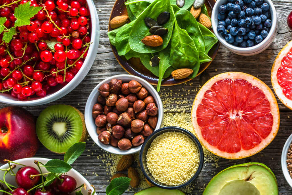 Selection of healthy food. Superfoods, various fruits and assorted berries, nuts and seeds.
